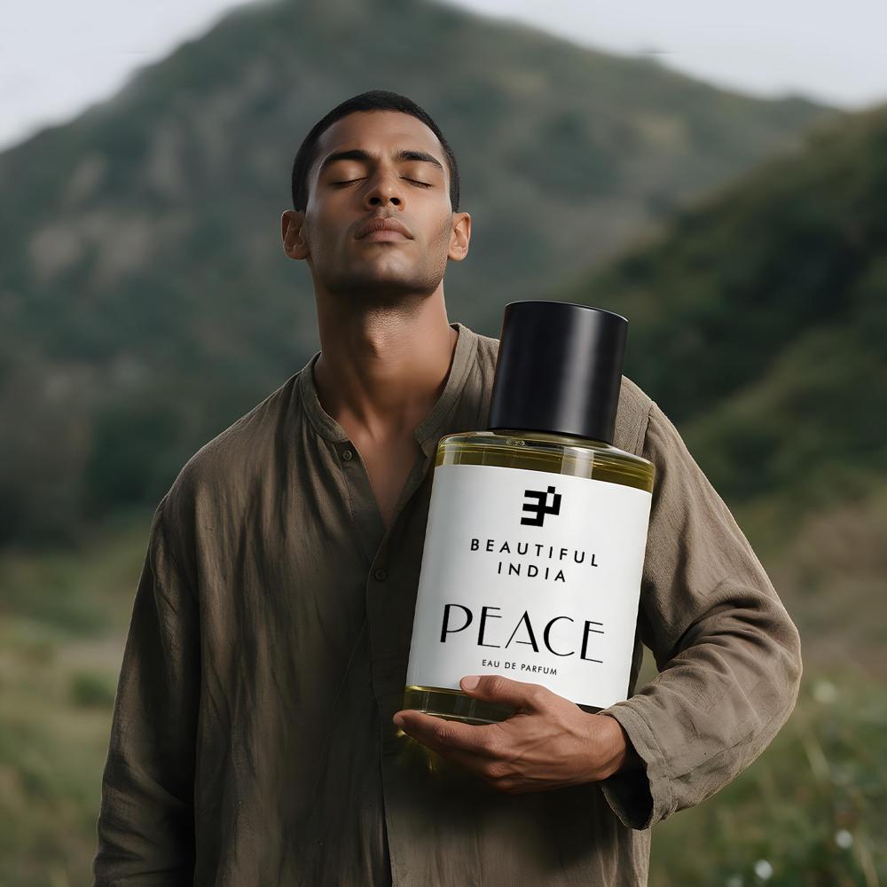 A man holding Peace Eau de Parfum before a green hillside