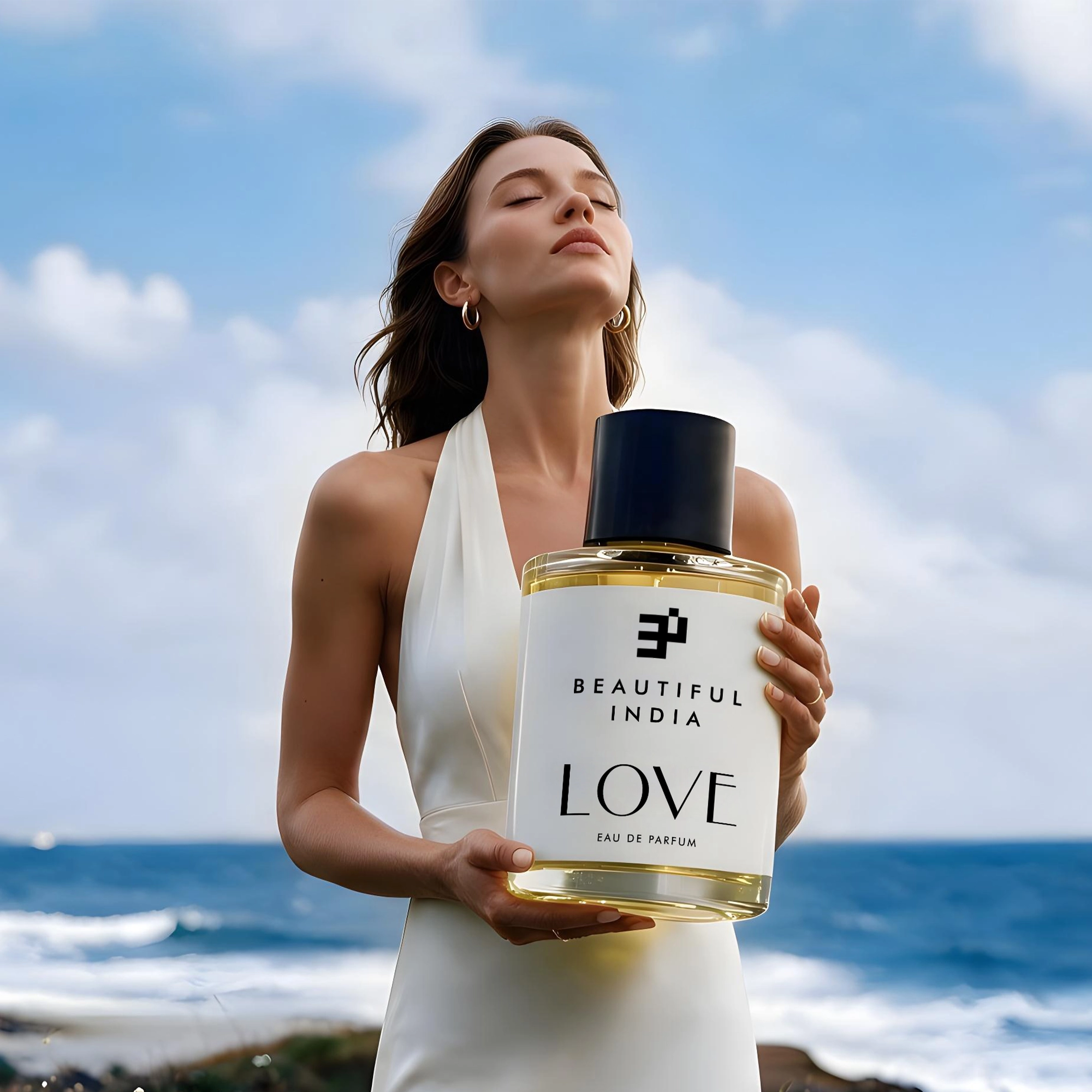 A woman holding Love Eau de Parfum by the sea