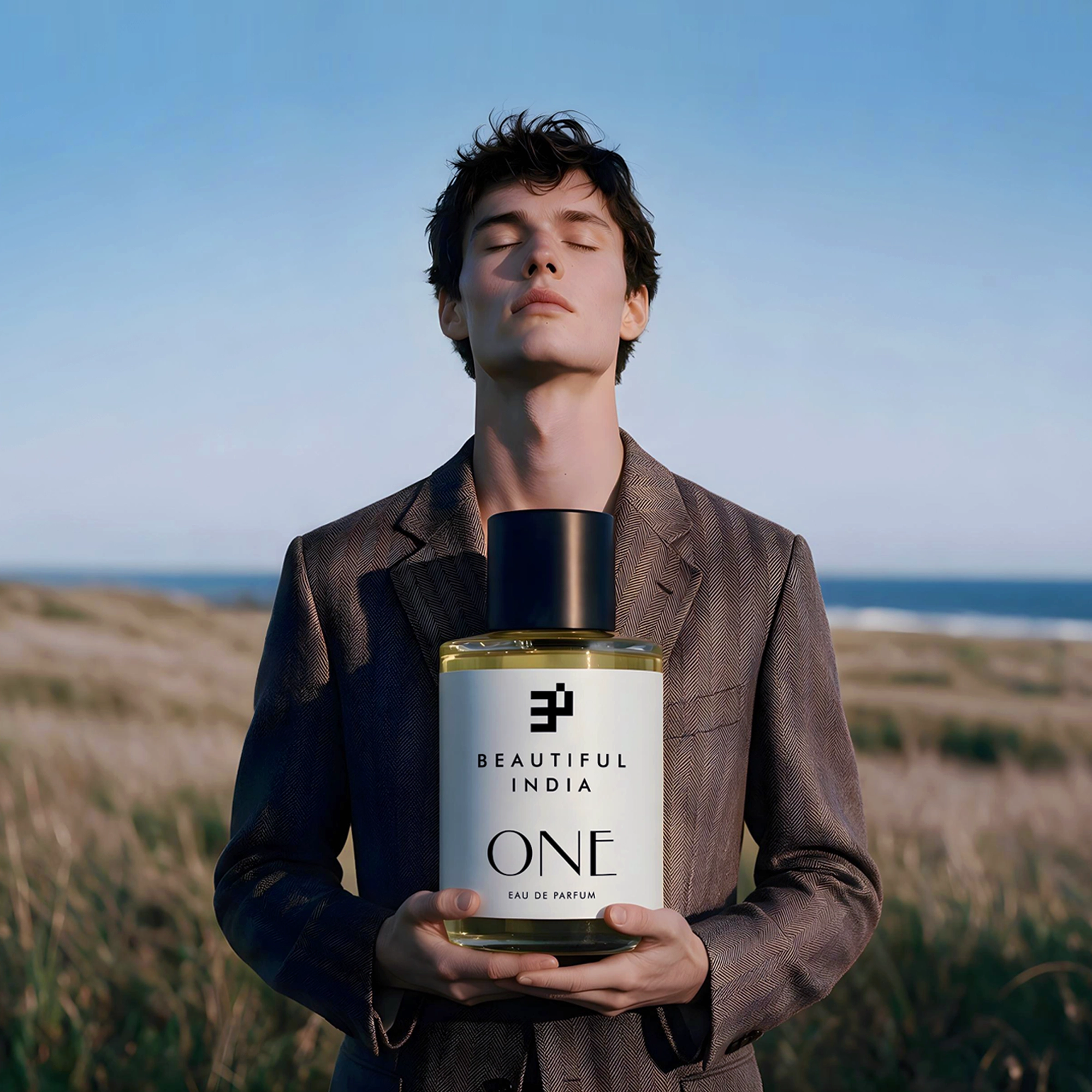 A man holding One Eau de Parfum in a coastal meadow